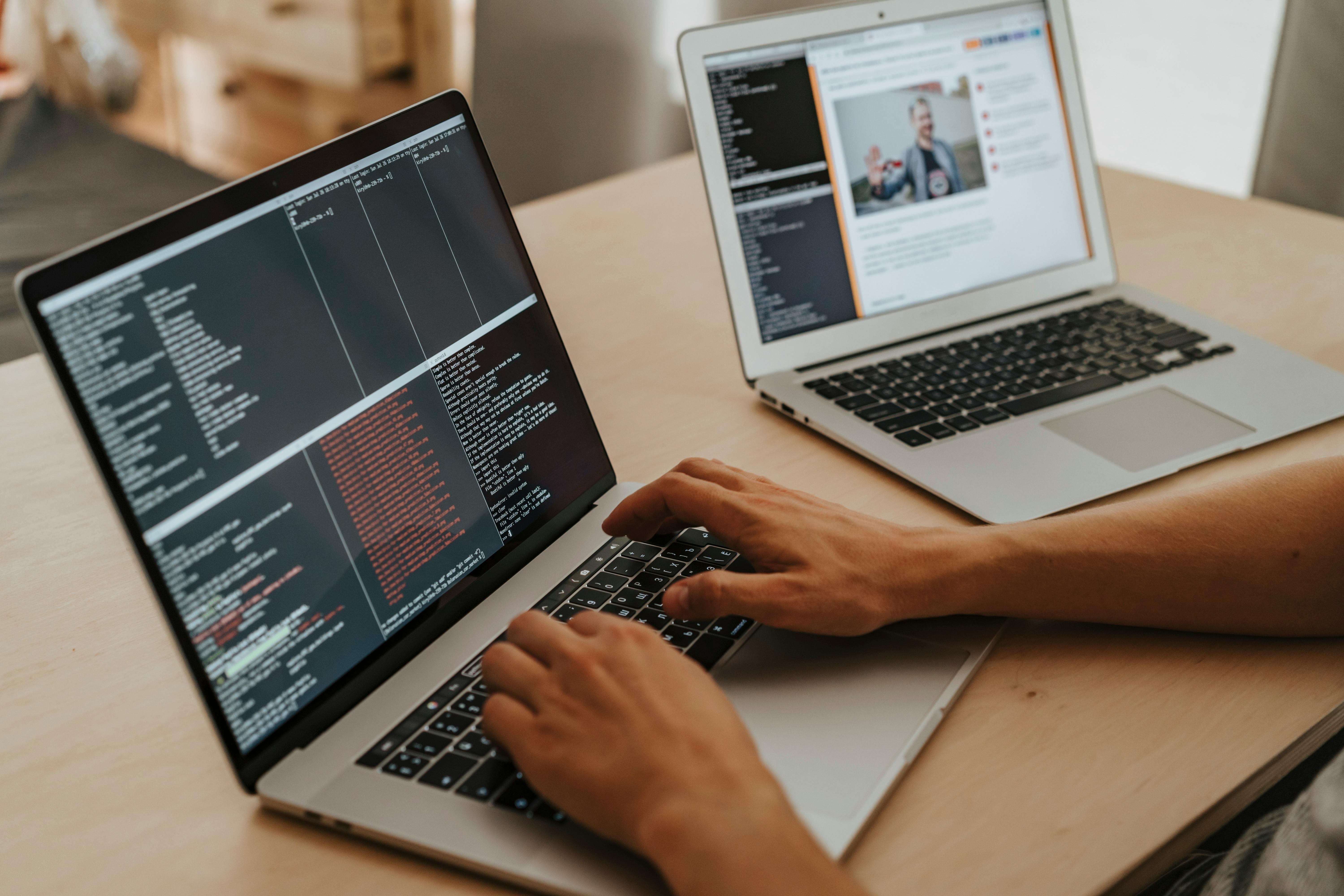 Developer workspace with laptops and coding